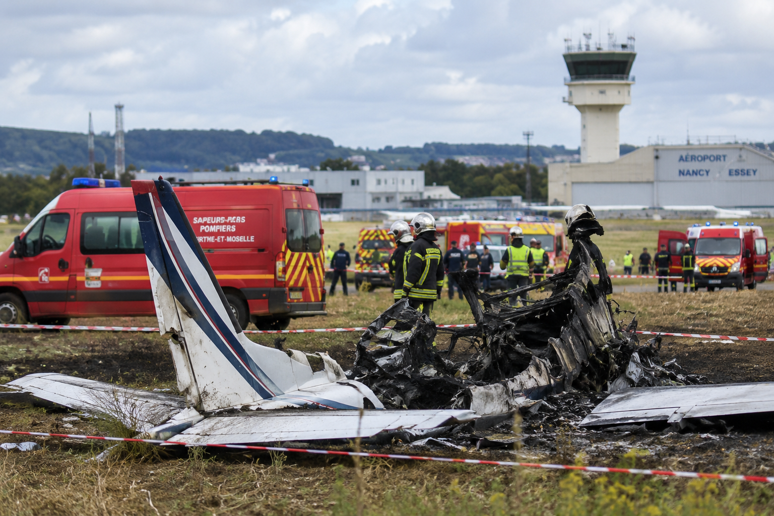 Emergency personnel investigate the scene of a skydiving plane crash near Nancy in northeastern France.