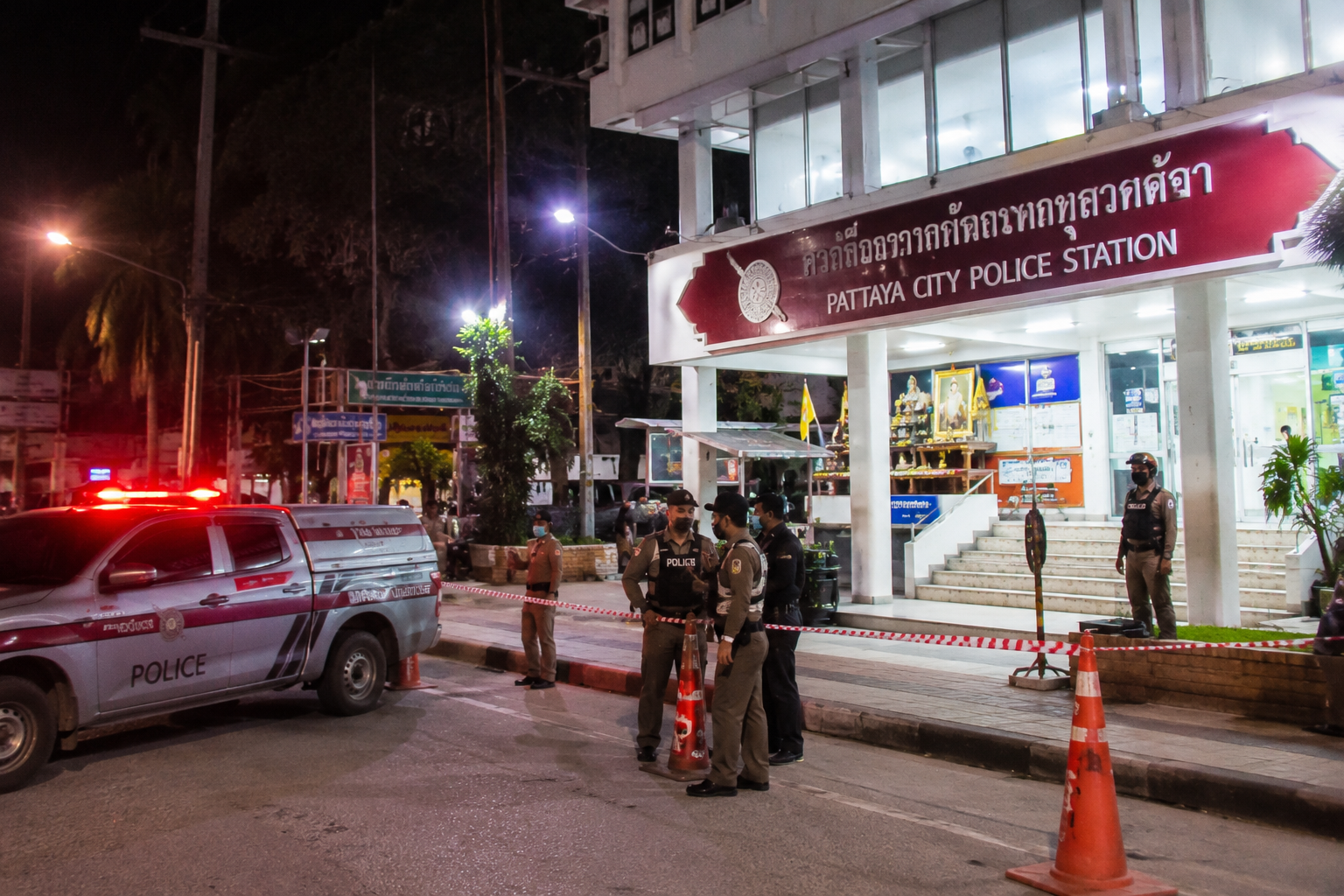 Police investigators work near a cordoned-off area during an active criminal investigation in Thailand.